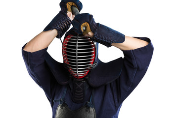 Male in tradition kendo armor with bamboo sword on white background. (unrecognizable person, dark mask) Shot in studio. Isolated with clipping path.