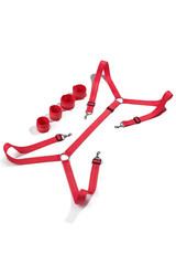 Detailed shot of red handcuffs with D-rings and long red binding belts with steel rings, lobster clasps and length adjusters. The accessory for erotic game is isolated on the white backdrop.