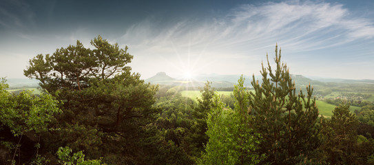 Panoramic landscape scenery at Saxon Switzerland with sun beams
