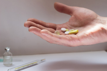 tablets in a man's hand on a white background