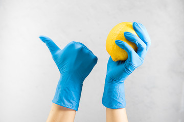 doctor's hands in medical gloves hold a lemon