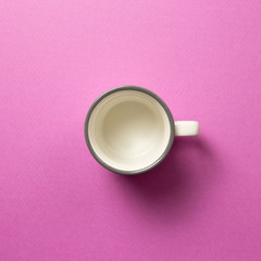 Empty cup on pink background. top view, copy space