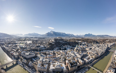 Obraz premium Aerial drone view of snowy Hohensalzburg fortress with view of Unesberg mountain in winter morning