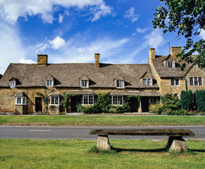 Wooden bench at tourist beauty spot in Cotswolds UK.