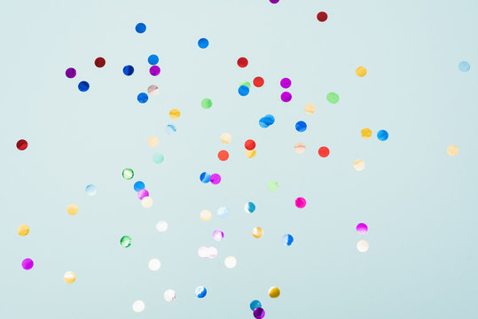 Confetti scattered on the light blue background. Bright dots on the background.