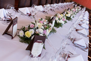 
floral decoration on table in party room for an event, decoration centerpieces with natural flowers
