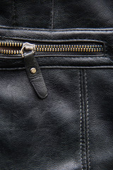 Back leather texture with open zipper on black leather