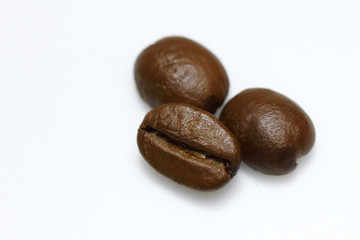 3 coffee beans isolated on white background. Selective spot focus. coffee beans brown roasted on white background. caffeine, espresso, seed