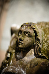Ancient weathered sculpture of a praying Angel