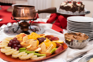 fresh fruits cut and on skewer on event candy table with fondue
