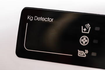 Washing machine display close up. Blank panel of the detector in kg. Abstract laundry programming backdrop.