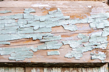 Wooden texture with cracked blue pastel paint. peeling paint on wood desk