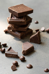 chocolate stack on grey background close up. natural daylight, vertical.