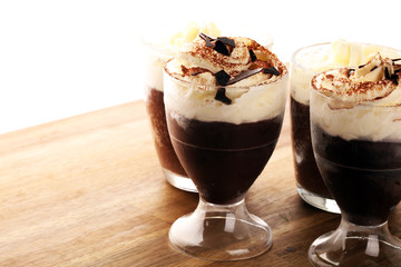 hot chocolate with cocoa and whipped cream on rustic background