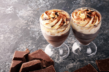 hot chocolate with cocoa and whipped cream on rustic background