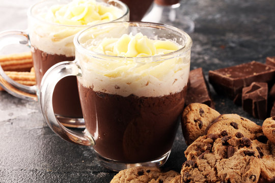 hot chocolate with cocoa and whipped cream on rustic background