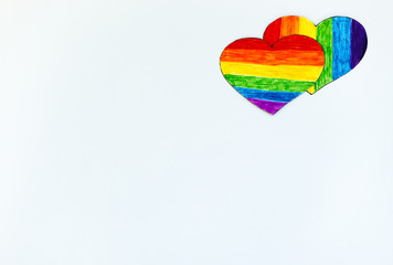 Two hearts in LGBT flag colors on white background. Romantic gay community dating.