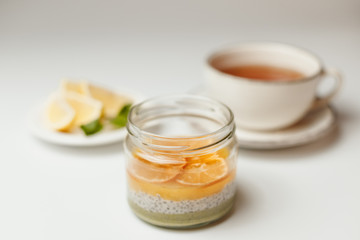 Chia pudding with orange and lemon tea on a white background