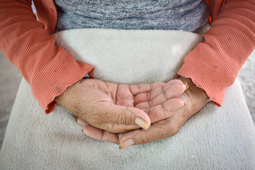 Fototapeta na wymiar The hand of the sick old woman rests on the lap. Mental health care at home.