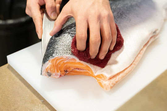 Color Image; Sushi; Table; Blue; Chef; Close-up; Cutting; Day; Fillet; Fish; Food; Food and Drink; Freshness; Healthy Eating; Horizontal; Human Body Part; Human Hand; Indoors; Japanese Food; Kitchen K