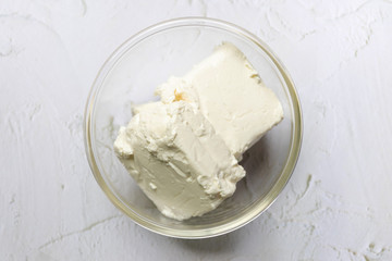 Bowl of cream cheese isolated on white background.