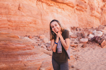 Beautiful girl on a background of nature of Egypt. Portrait photo of a girl traveler. In the background is the desert. Photo for tour agency
