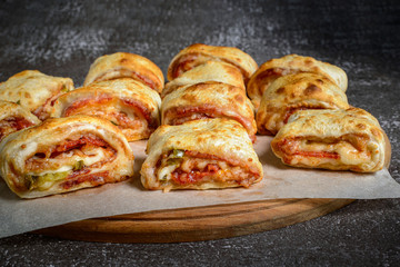 Mini pizza rolls on wooden board