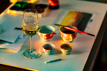 glass of wine on the artists work table