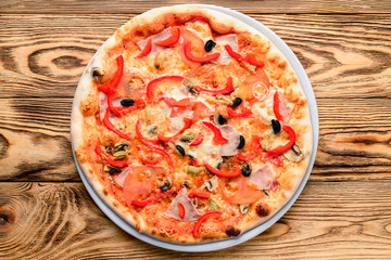 Delicious italian pizza served on wooden table