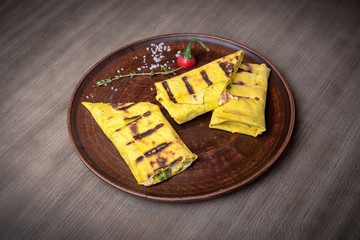 Baked pancake with salt filling, meat, cheese, mushrooms with sauce. restaurant giving. for the menu of cafe. wooden table. side view