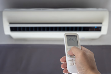 remote air condition on hand, save power concept