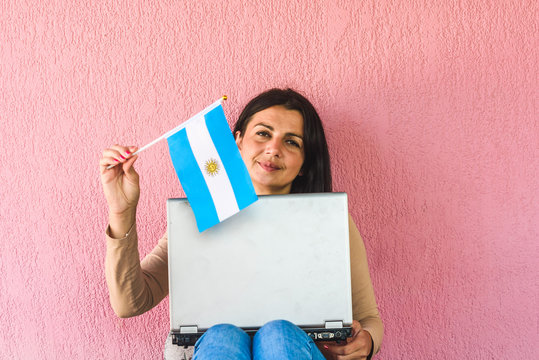 woman with laptop computer and flag of  Argentina - Powered by Adobe