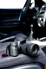Digital SLR or DSLR camera on the front passenger seat of a car