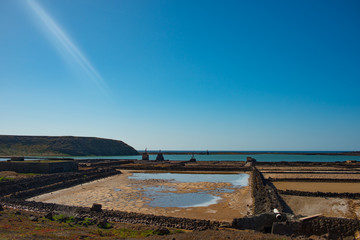 Fototapeta na wymiar Aerial view on the salt production fields on Lanzarote island on a sunny day 