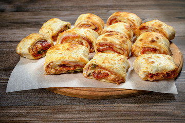 Mini pizza rolls on wooden background