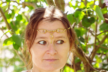 Closeup of young womans head wearing romantic metal tiara on her forehead © marbenzu