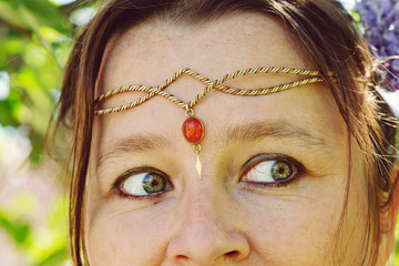Closeup of young womans head wearing romantic metal tiara on her forehead © marbenzu