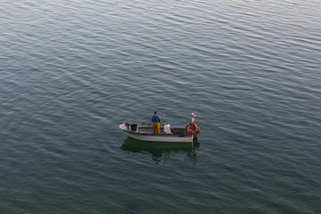 Naklejka premium Fisherman on a small boat