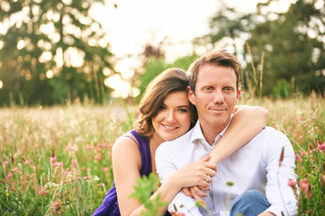 Fototapeta premium Outdoor portrait of happy couple enjoying nice warm evening in nature