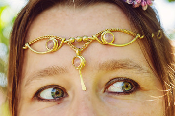 Closeup of young womans head wearing romantic metal tiara on her forehead © marbenzu