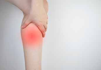 A woman suffers from pain in the calves. Stretching the calf muscle, varicose veins, leg cramps, or myositis. Orthopedic doctor examines patient