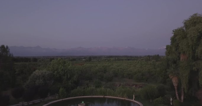 Ungraded, Straight aerial flight above pond towards reddish mountain range of Cordillera de los Andes. Drone, 4K. 
Valle de Uco, Tupungato, Mendoza, Patagonia, Argentina
