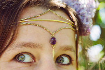 Closeup of young womans head wearing romantic metal tiara on her forehead