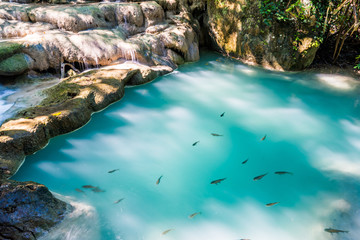 Waterfall and blue emerald water color in Erawan national park. Erawan Waterfall tier, Beautiful nature rock waterfall steps in tropical rainforest at Kanchanaburi province, Thailand