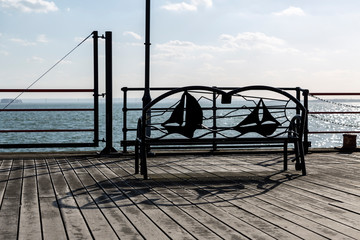 Metal Bench in Front of a Sea or Lake.