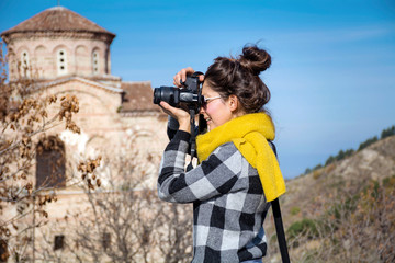 Woman Holding Photo Camera. .Travel Photographer Taking Photos Outdoor  in the City