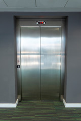 Modern elevator with closed doors in an office building.