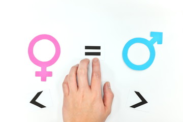 Fototapeta premium Gender equality concept. Hand putting equal sign between male and female symbol.