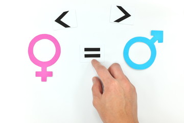 Gender equality concept. Hand holding equal sign between male and female symbol.