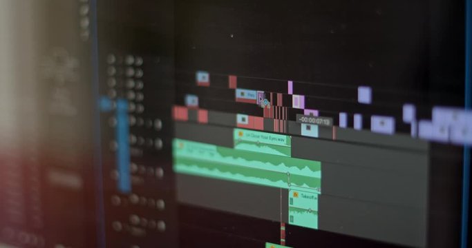 Close up of video editing time line and computer monitor as video editor works on an edit